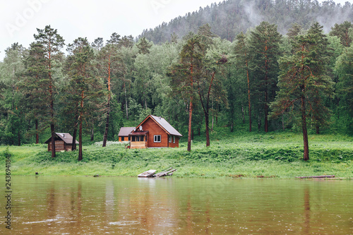 small house in the forest on the river Bank