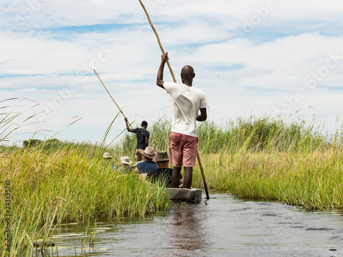 Local man working on Mokoro to deliver tourists and campers across the rivers of the Delta Okawango, Botswana