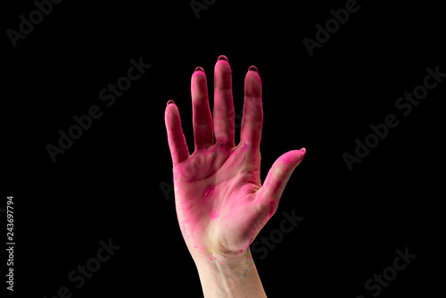 cropped view of adult woman showing pink holi powder on hand isolated on black © LIGHTFIELD STUDIOS