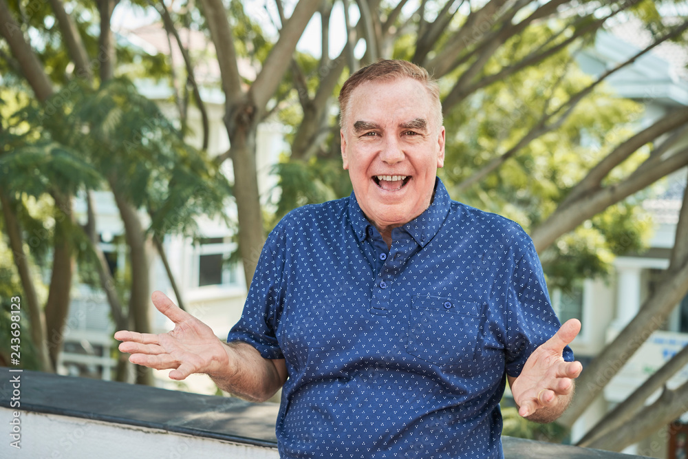 Portrait of happy excited senior man standing outdoors Portrait of happy excited senior man standing outdoors