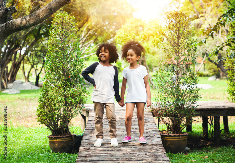 Fototapeta premium Children playing in the garden in summer day
