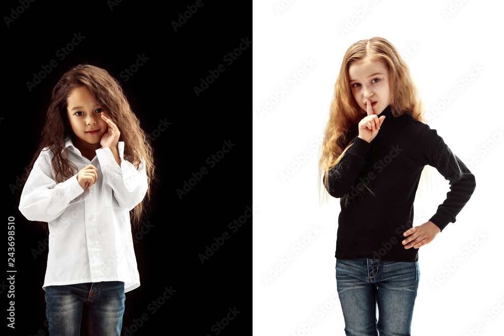 Secret, gossip concept. Young girls whispering a secret behind her hand isolated on white and black studio background. Young emotional girl. Human emotions, facial expression concept. Secret, gossip concept. Young girls whispering a secret behind her hand isolated on white and black studio background. Young emotional girl. Human emotions, facial expression concept.