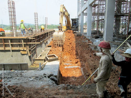 Photography KUALA LUMPUR, MALAYSIA -MARCH 16, 2017: Excavation and ground levelling work using excavator machine and other heavy construction machinery at the construction site
