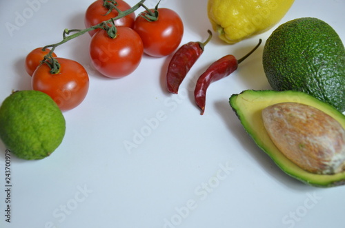 Ingredients for guacamole on white background. cherry tomatoes, chilli peppers, avocados, ingredients for mexican food