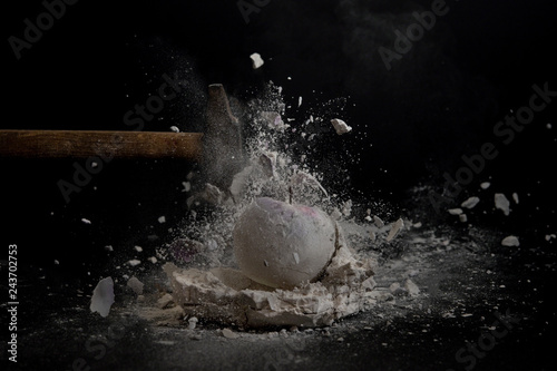 Hammer smashing a Mould of a chalk apple into pieces