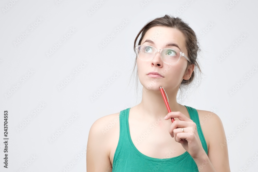 Confused girl thought with a pencil. I do not know this rule. Confused girl thought with a pencil. I do not know this rule.
