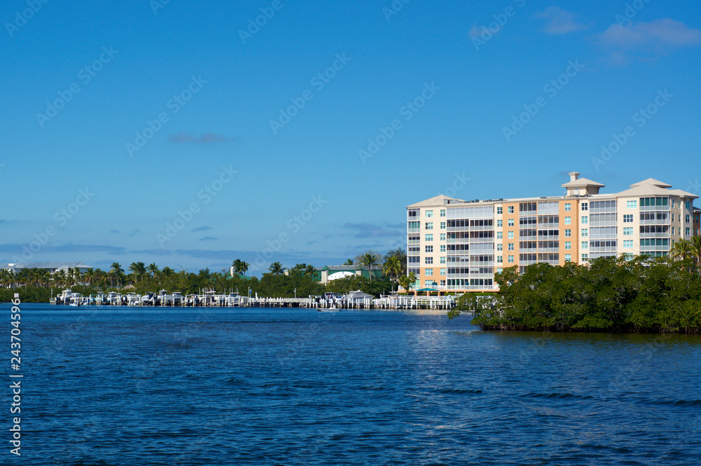 Scenic view of Bonita Springs Florida, looking across canal towards large building and boat docks. Scenic view of Bonita Springs Florida, looking across canal towards large building and boat docks.