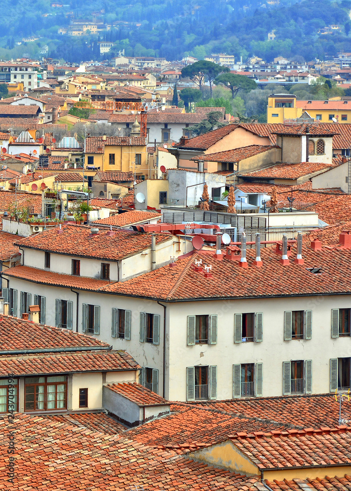 Top view. Red tile roofs of Italian buildings in the city. Urban landscape. Italy. Top view. Red tile roofs of Italian buildings in the city. Urban landscape. Italy.