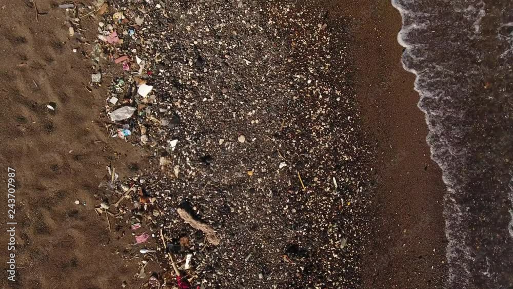 Aerial shot of beach covered in plastic pollution