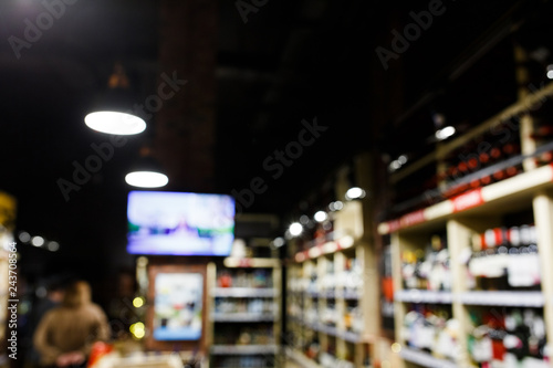 Defocused image of shelves with multi-colored bottles of wine
