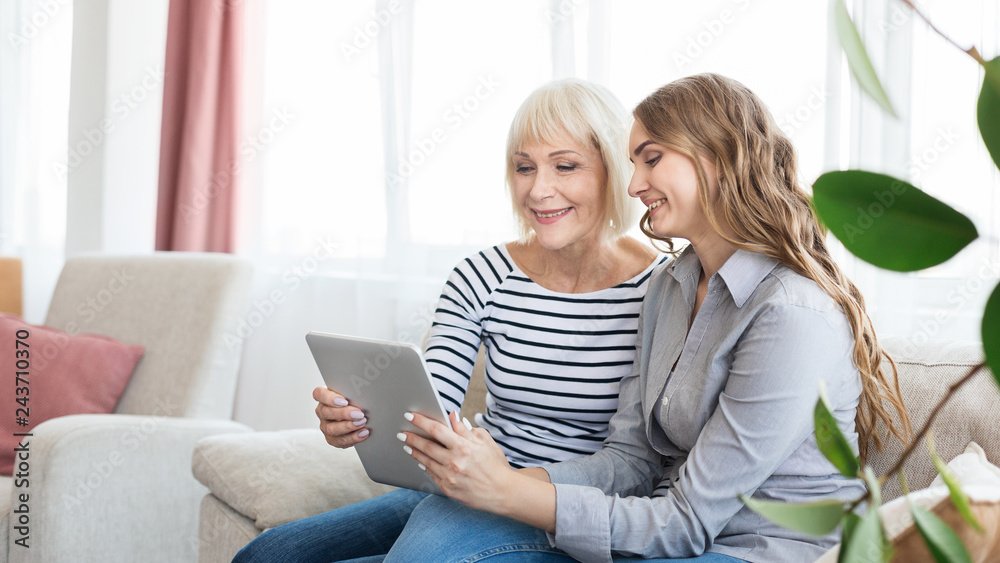 Senior mother and daughter using tablet, watching video Senior mother and daughter using tablet, watching video