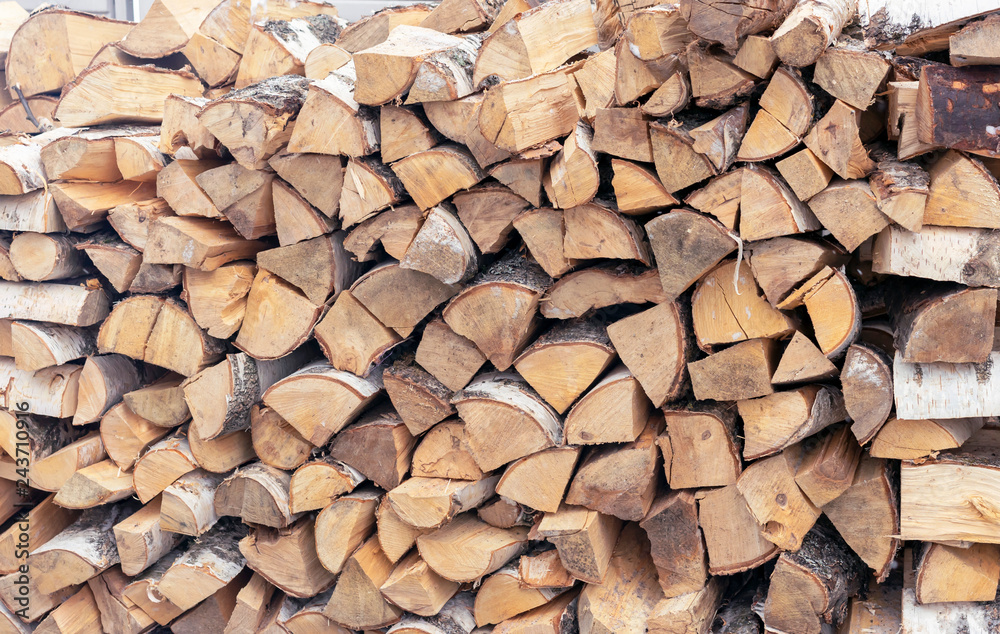 Firewood for a fireplace stacked in a woodpile. Firewood for a fireplace stacked in a woodpile.