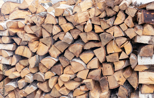 Firewood for a fireplace stacked in a woodpile.