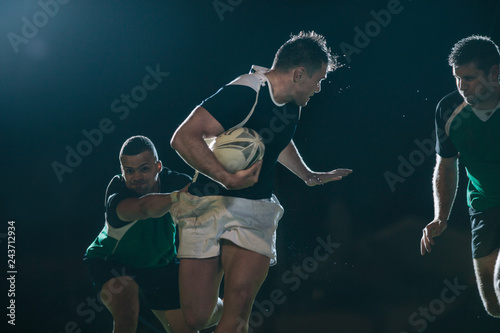Photography Rugby player running with ball and tackling