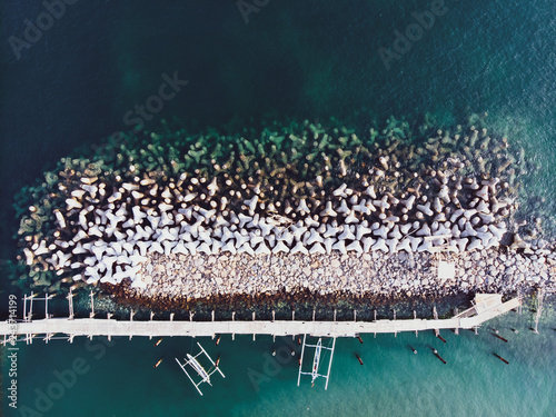 Concrete breakwaters. Seascape with concrete tetrapodes to protect coastal structures from destructive impact of storm sea waves. Tetra-pods, concrete blocks. Strengthening of concrete sea. Breakwater