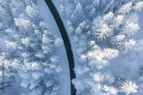 Aerial view of a winding road through snow covered trees, Gaisberg, Salzburg, Austria photo