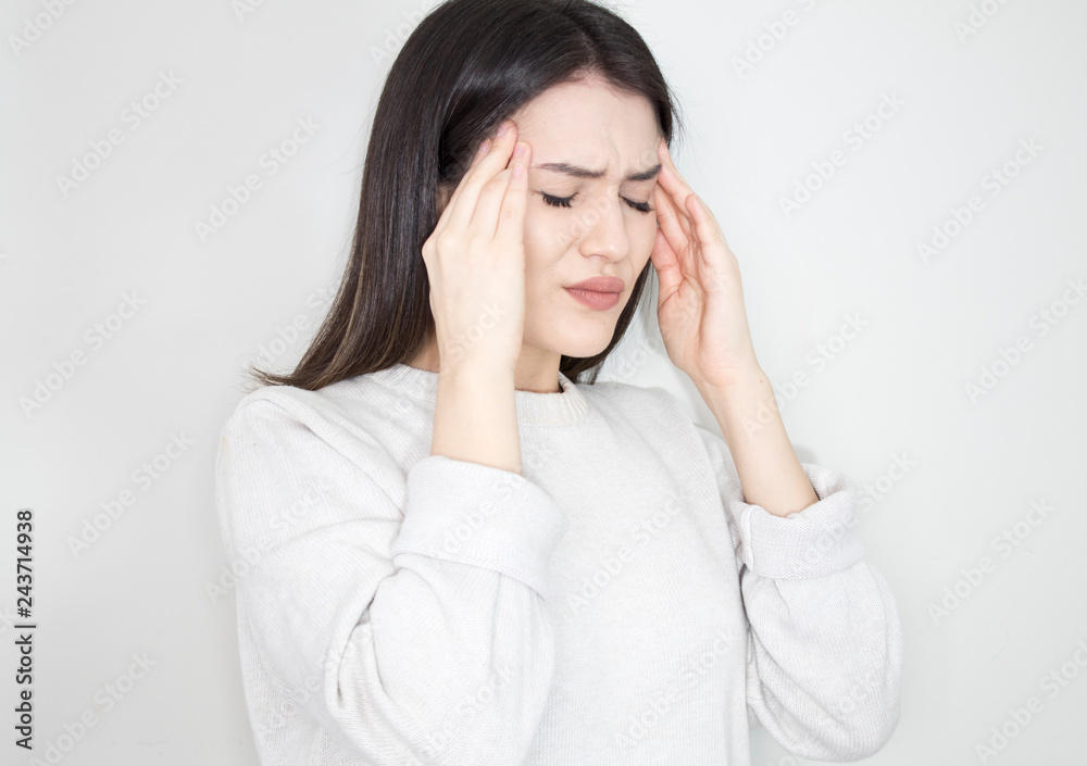 Young beautiful woman has headache, isolated on gray background Young beautiful woman has headache, isolated on gray background