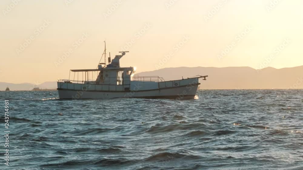 White private motor yacht in the sea on sunset White private motor yacht in the sea on sunset
