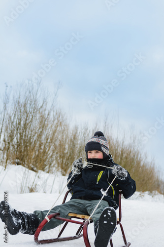 Happy small boy in winter snow covered courtyard © Niko_Dali