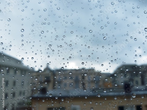 Genova, Italy - 10/28/2018: An amazing photography of some waterdrops over the window after summer rain in the city