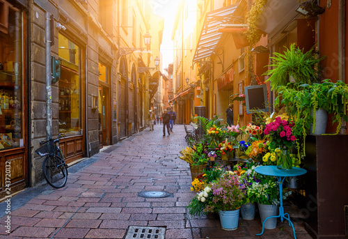 Old narrow street with flower shop in Bologna, Emilia Romagna, Italy