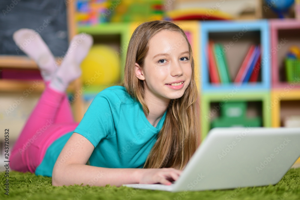 Portrait of cute girl with laptop computer on floor Portrait of cute girl with laptop computer on floor