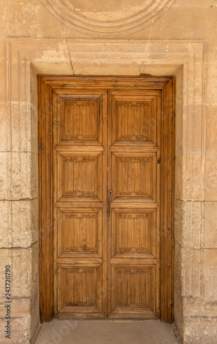 Classic solid wood door in one of the buildings of the Alhambra, Granada