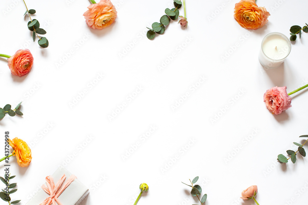 Floral concept frame on the with background with a gift and a candle. Top view Mothers day or Womens day card. Copy space Floral concept frame on the with background with a gift and a candle. Top view Mothers day or Womens day card. Copy space