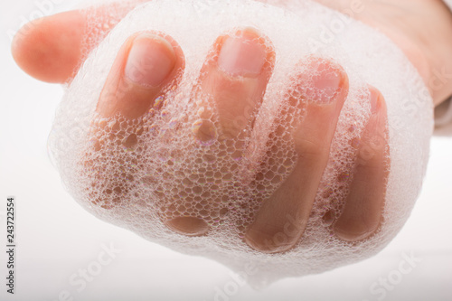 Child washing hands in foam