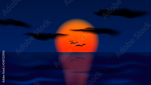 Sunset on the horizon of the sea. On the background of the sun are visible silhouettes of birds.
