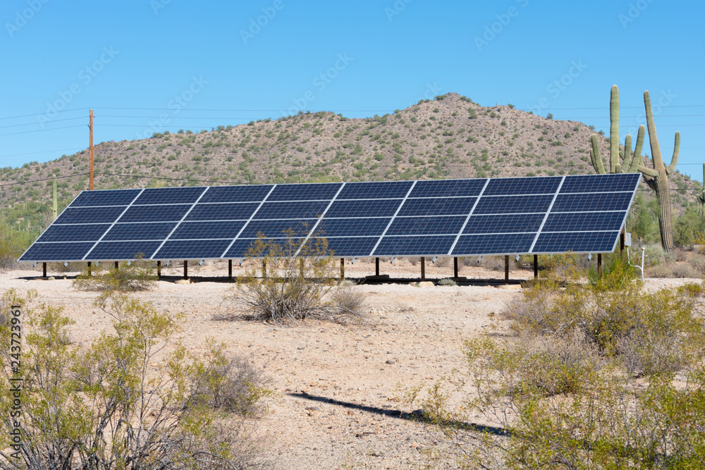 Solar panels on a hill side in the desert Solar panels on a hill side in the desert