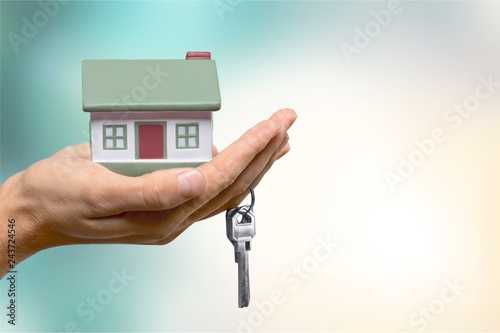 Businessman Holding House Model and Keys, Real Estate Concept