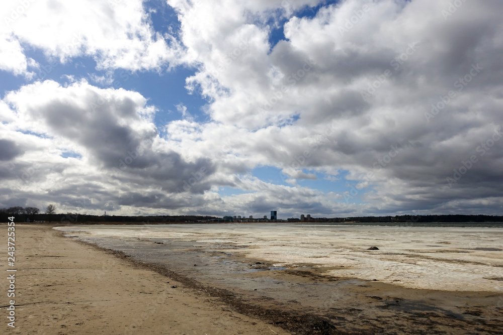 the city beach in the spring. the snow is melting.