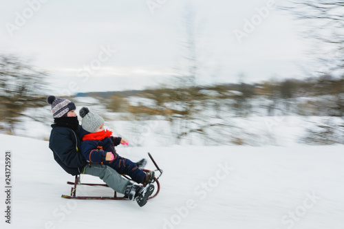 Small boy sledding at winter time. Motion blur