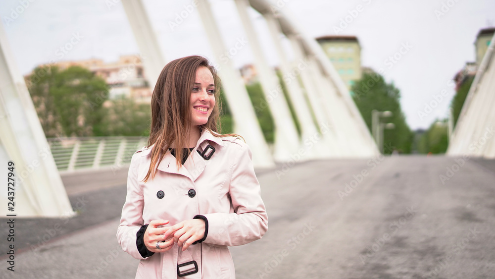 Fototapeta premium European girl having holidays in Rome, Italy. Attractive woman with beautiful smile and adorable eyes posing on the Roman bridge. Italian fashion 