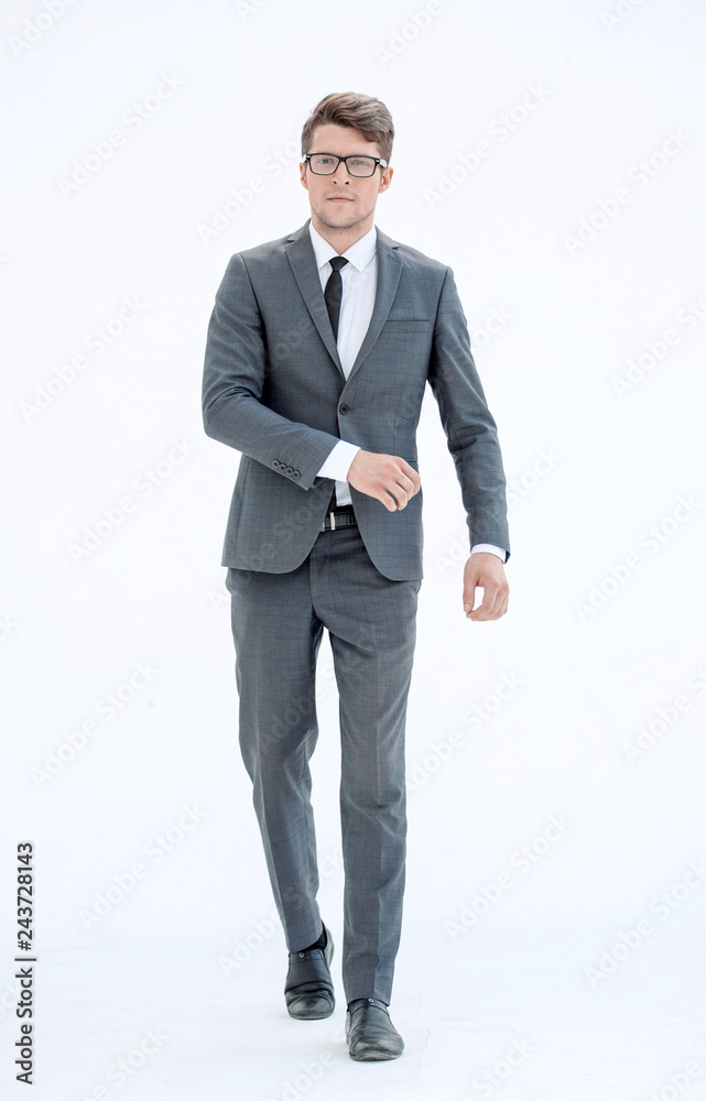 in full growth. confident businessman goes forward in full growth. confident businessman goes forward