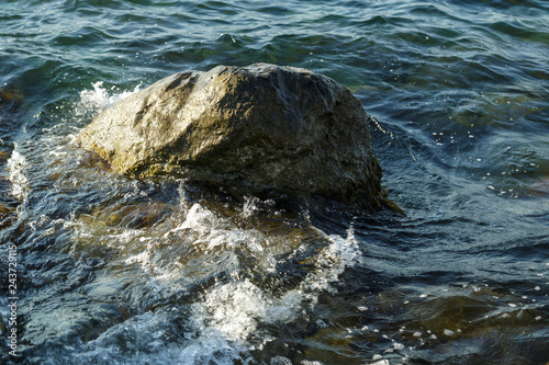 Rocks seen from the water into the sea and the waves.