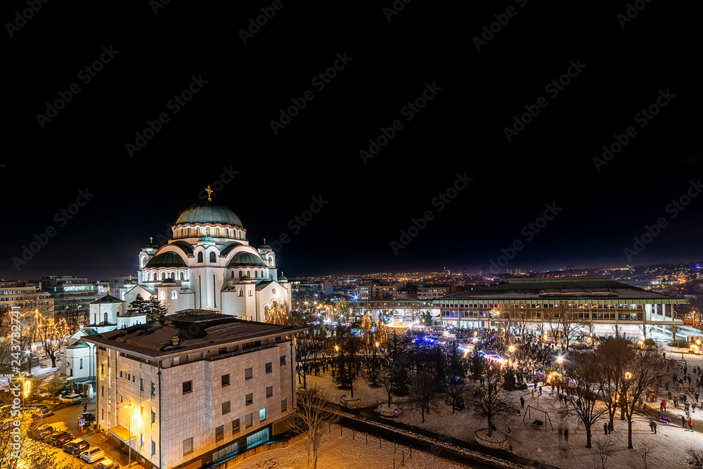 Fototapeta premium Belgrade, Serbia - January 14, 2019: Orthodox Church Saint Sava and National Library of Serbia by night