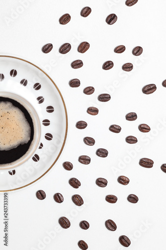 Cup of coffee with coffee beans picture on white table