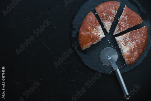 Fresh baked bread sliced into pieces on black background.Top view.percentage concept