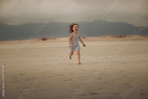girl running on the beach © Natalia