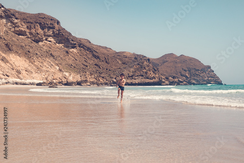 boy running on the beach