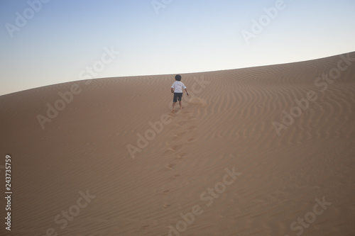 boy going up the sand dune
