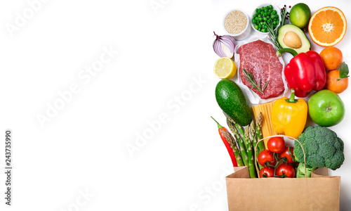 Healthy food background. Healthy food in paper bag meat beef, fruits, vegetables and pasta on white background. Shopping food supermarket concept. Long format with copy space