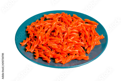 Gluten free red lentils pasta on a dark plate isolated on white background. side view. copy space. close up