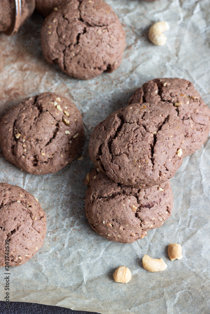 Delicious chocolate cookies with nuts on dark old concrete table. Copy space. Delicious chocolate cookies with nuts on dark old concrete table. Copy space.