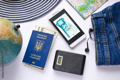 Airline tickets. Travel accessories. Tools for navigation. Ukrainian international biometric passport. Free visa law in Ukraine. Traveliing concept. photo