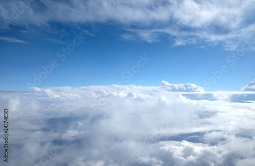 Beautiful sky landscape with view from the plane above dense white clouds high in the stratosphere on a sunny day horizontal photo © DyMaxFoto