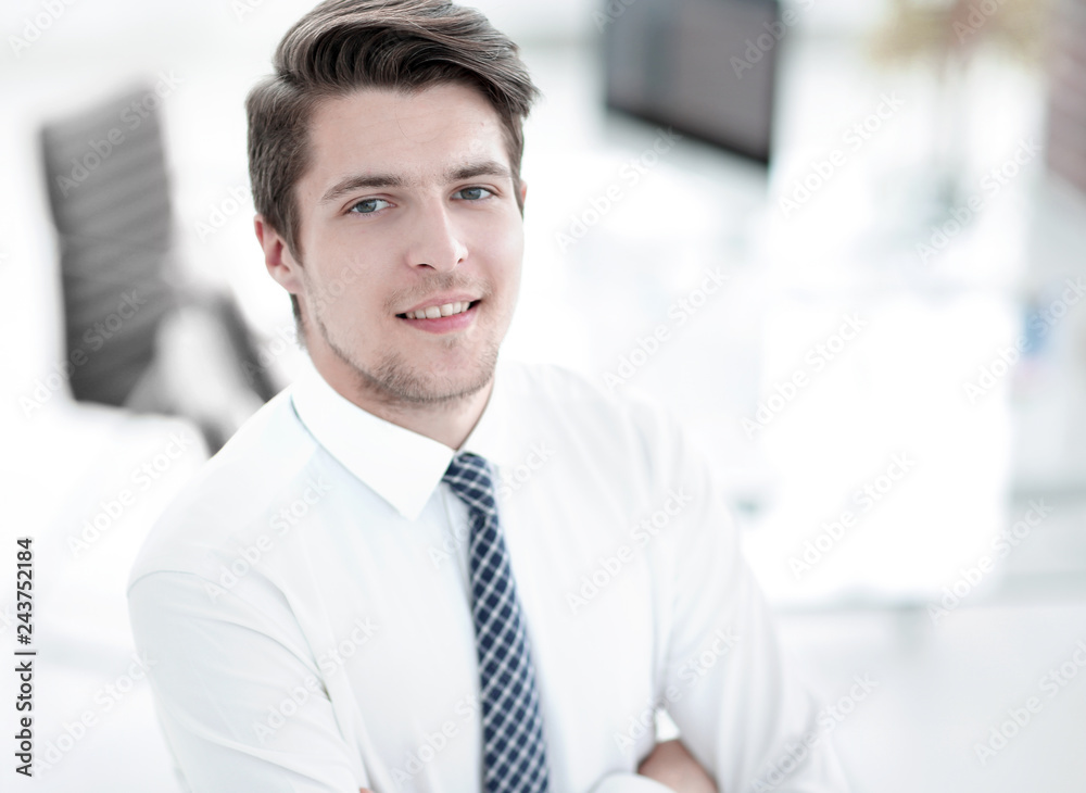 confident young businessman on background of office confident young businessman on background of office