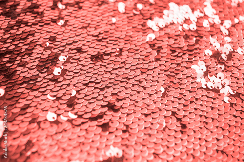 Coral glittery sequins background with blinking details.